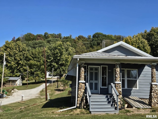 bungalow-style home with a front yard and a porch