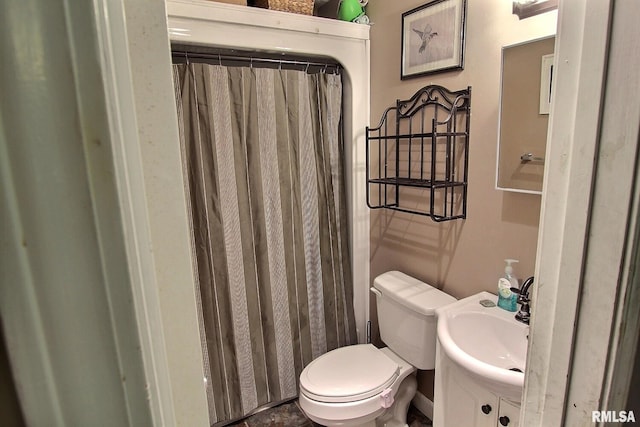 bathroom with toilet, curtained shower, and vanity