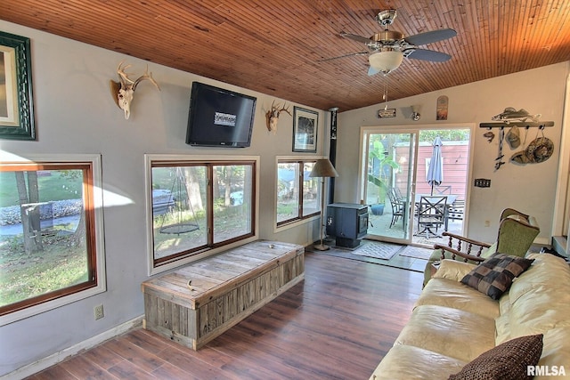 living room featuring ceiling fan, wooden ceiling, vaulted ceiling, a wood stove, and dark hardwood / wood-style floors