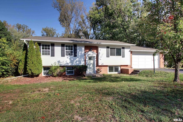 split foyer home featuring a garage and a front yard