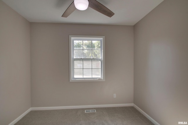 empty room featuring carpet flooring and ceiling fan