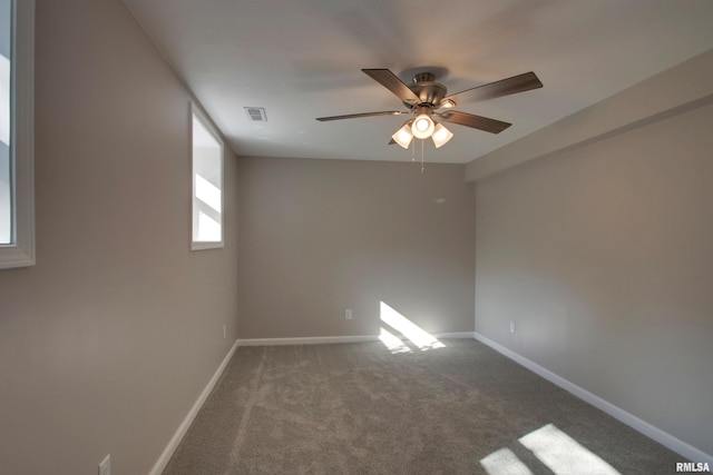 carpeted spare room with ceiling fan