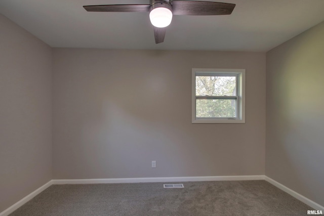 carpeted spare room with ceiling fan