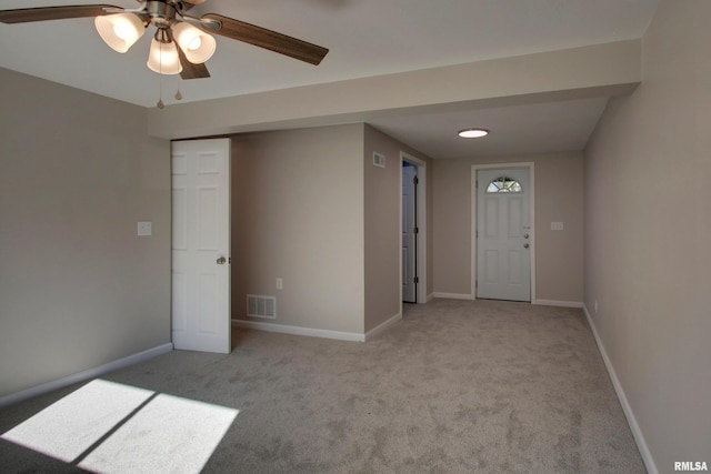 carpeted entryway featuring ceiling fan