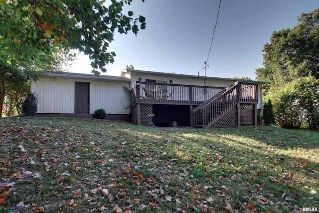 back of property with a lawn and a wooden deck