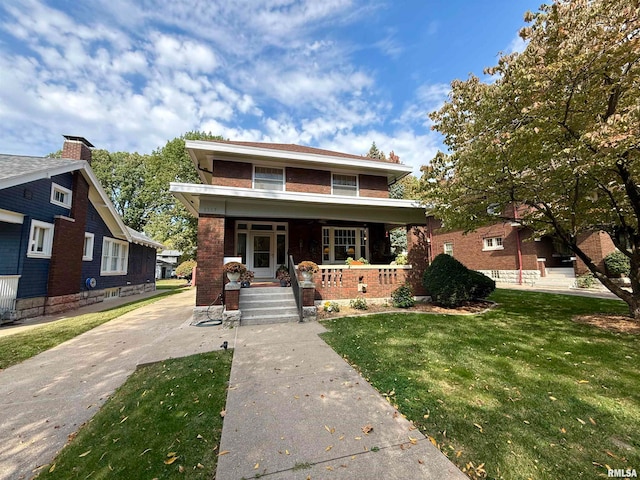 view of front facade with a front lawn and covered porch