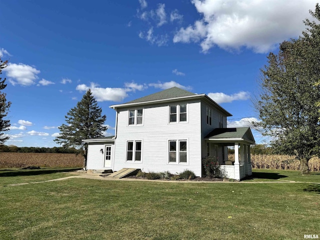 rear view of property with a yard