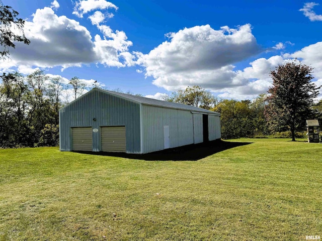 view of outdoor structure with a lawn and a garage