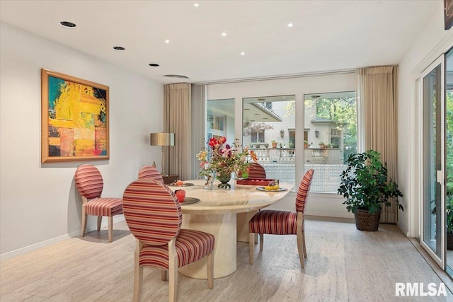 dining space with light hardwood / wood-style floors and plenty of natural light