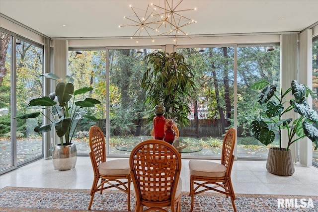 sunroom with a healthy amount of sunlight and an inviting chandelier