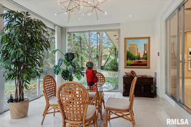 dining space featuring a wall of windows and a notable chandelier