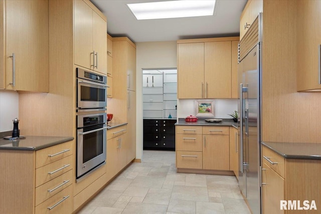 kitchen featuring appliances with stainless steel finishes and light brown cabinets