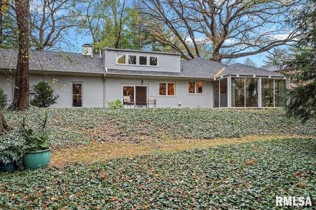 rear view of property with a sunroom