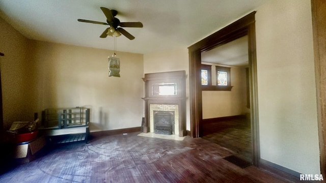 unfurnished living room featuring ceiling fan and dark wood-type flooring