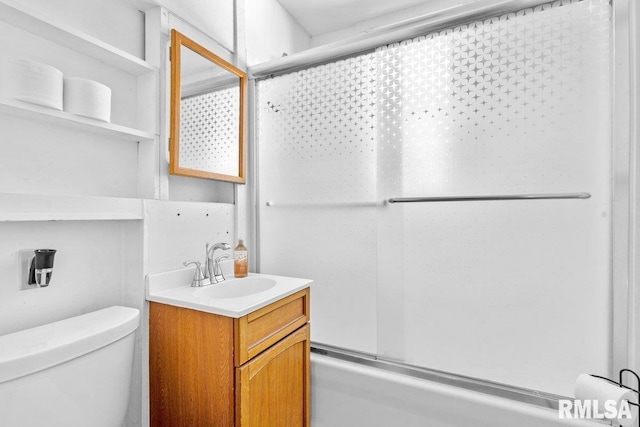 full bathroom with vanity, combined bath / shower with glass door, and toilet