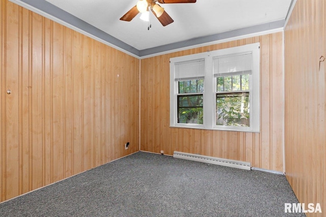 unfurnished room with ceiling fan, a baseboard radiator, wooden walls, and dark colored carpet