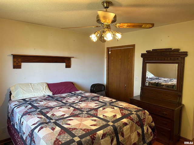 bedroom with a textured ceiling and ceiling fan