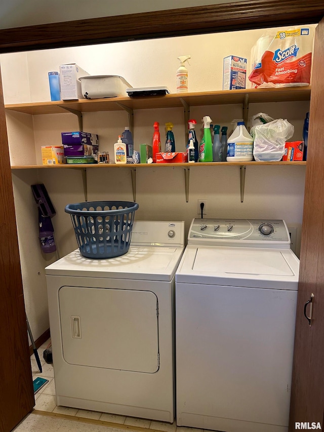 laundry area with washing machine and dryer and light tile patterned floors