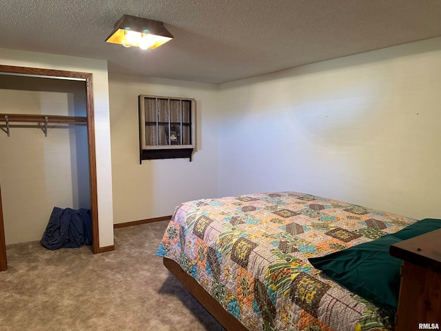 carpeted bedroom with a closet and a textured ceiling