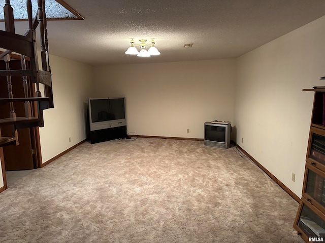 unfurnished living room featuring a textured ceiling and carpet