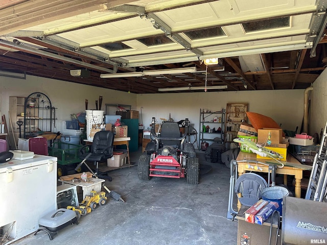 garage with a garage door opener and white refrigerator