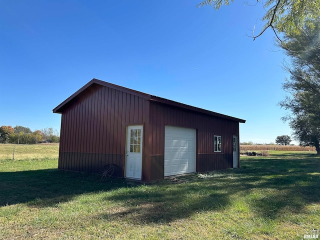 view of outbuilding featuring a yard and a garage