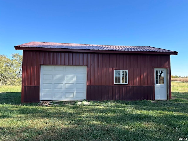 garage with wood walls and a lawn