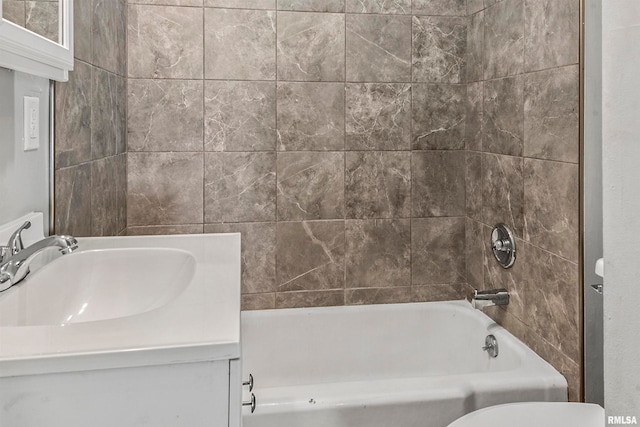 full bathroom with vanity, toilet, and tiled shower / bath combo