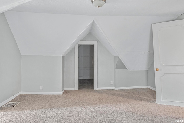 bonus room featuring carpet and vaulted ceiling