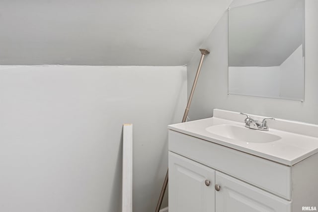 bathroom featuring vanity and vaulted ceiling