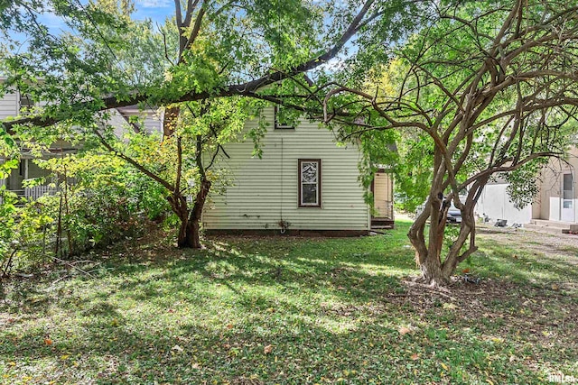 view of property exterior featuring a lawn