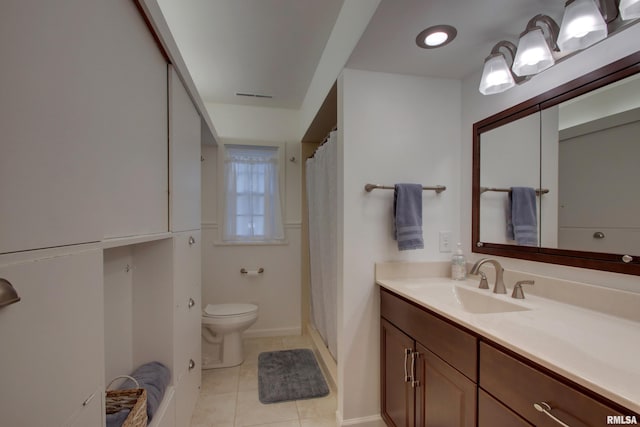 bathroom with vanity, toilet, tile patterned floors, and curtained shower