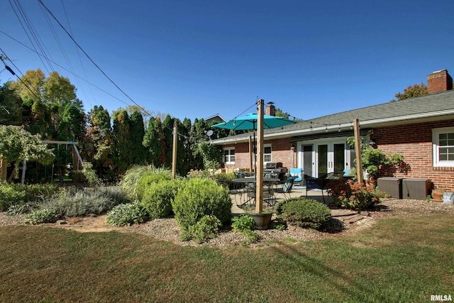 view of yard with french doors and a patio area