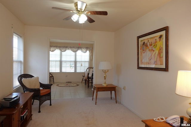 sitting room featuring ceiling fan and light colored carpet