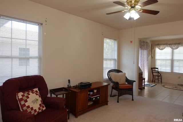 sitting room with light carpet, plenty of natural light, and ceiling fan