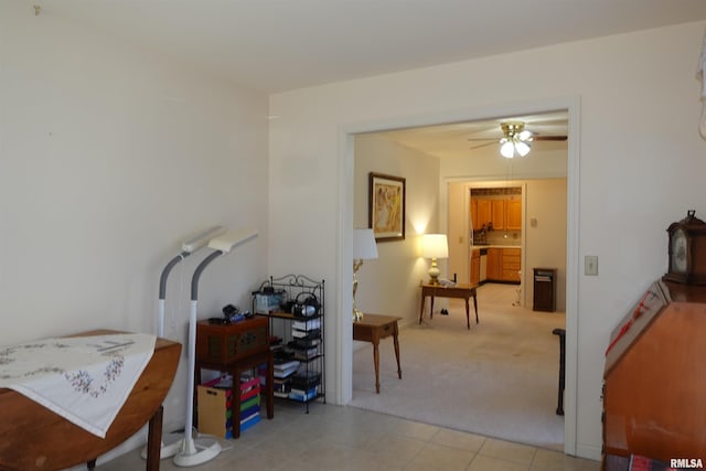 interior space with ceiling fan and light colored carpet