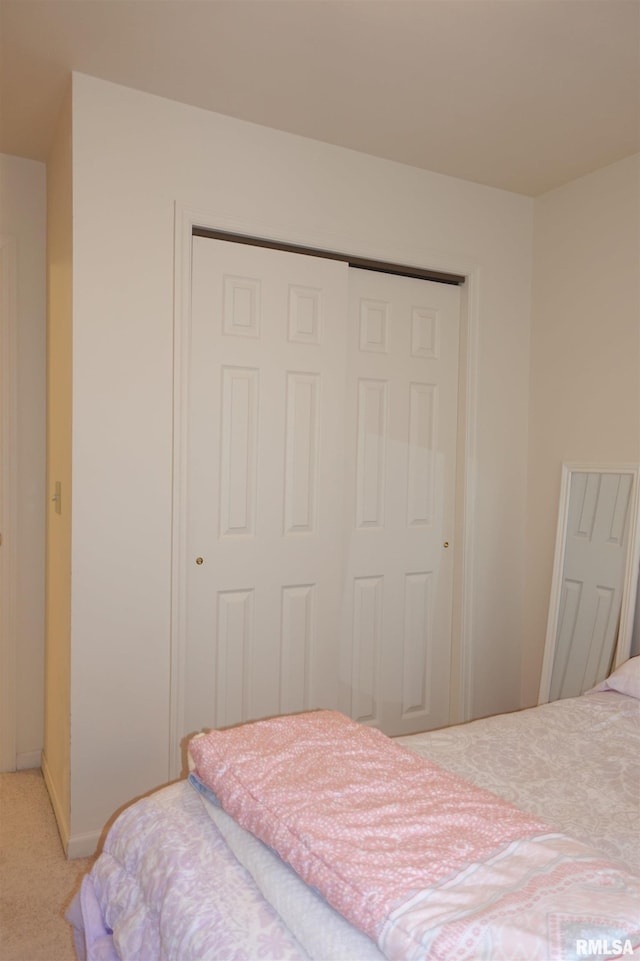 carpeted bedroom with a closet