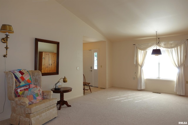 sitting room with a wealth of natural light, light carpet, and lofted ceiling