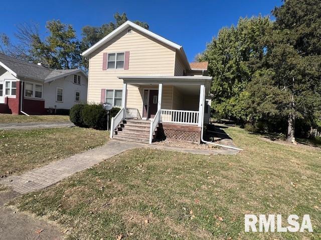 view of front facade with a front yard and a porch