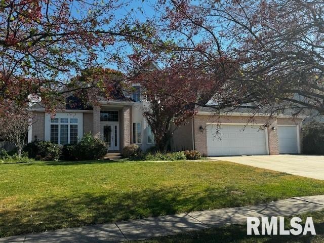 view of front of property featuring a front yard and a garage