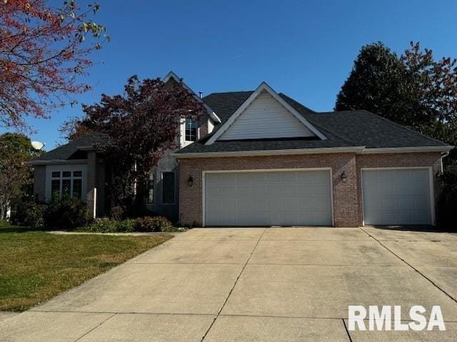 view of front of property with a garage and a front lawn