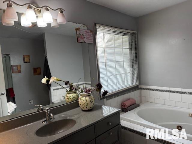 bathroom with tiled bath and vanity