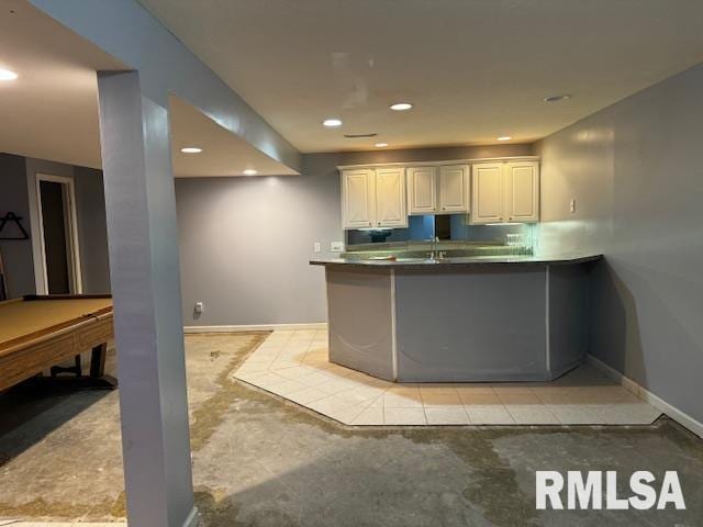 kitchen featuring sink, white cabinetry, kitchen peninsula, and pool table