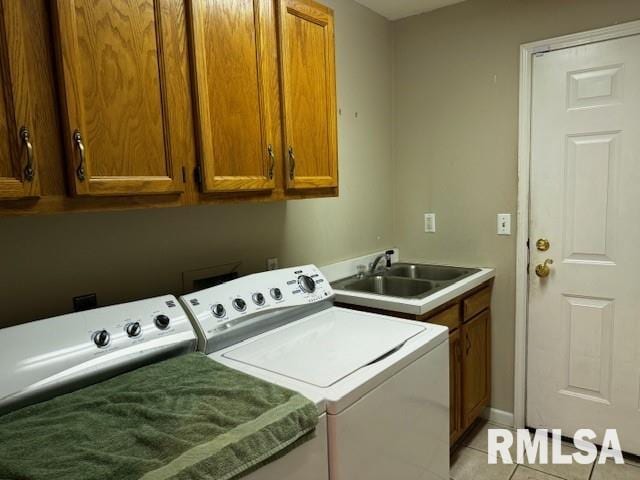 washroom featuring cabinets, separate washer and dryer, light tile patterned flooring, and sink