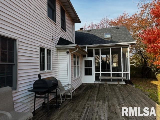 wooden terrace with a sunroom