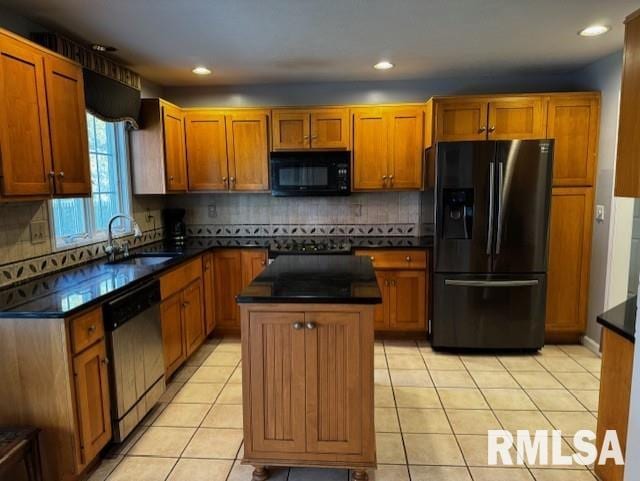 kitchen featuring decorative backsplash, sink, black appliances, light tile patterned floors, and a kitchen island