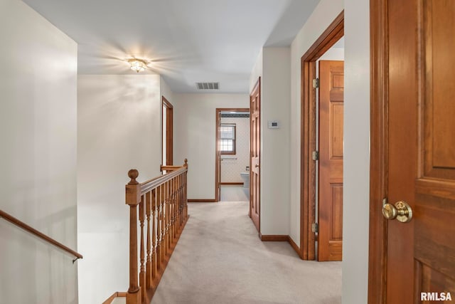 hall featuring light colored carpet