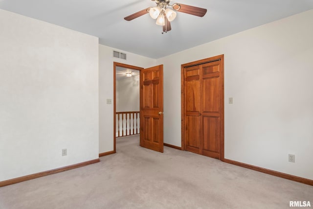 unfurnished bedroom with light colored carpet and ceiling fan