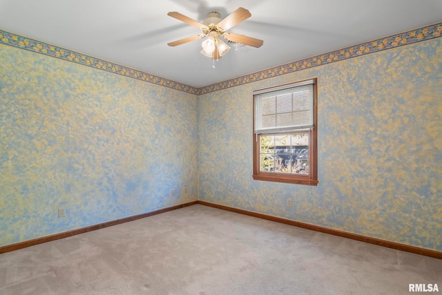 empty room featuring carpet flooring and ceiling fan