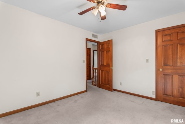 empty room with ceiling fan and light colored carpet